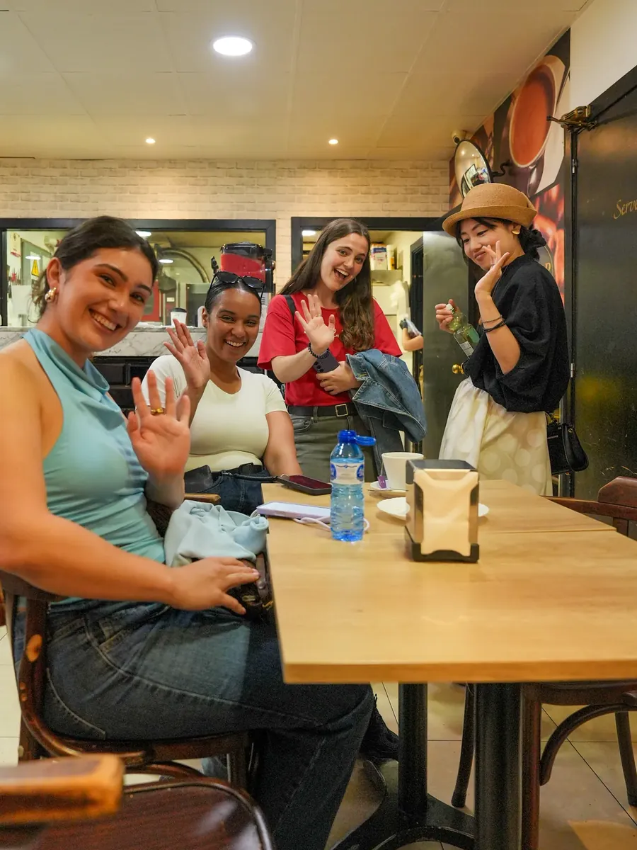 Blau students around a café table, laughing