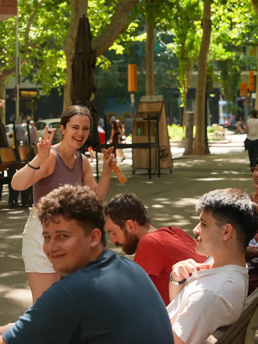 Blau students chatting on a bench on the Rambla del Poblenou