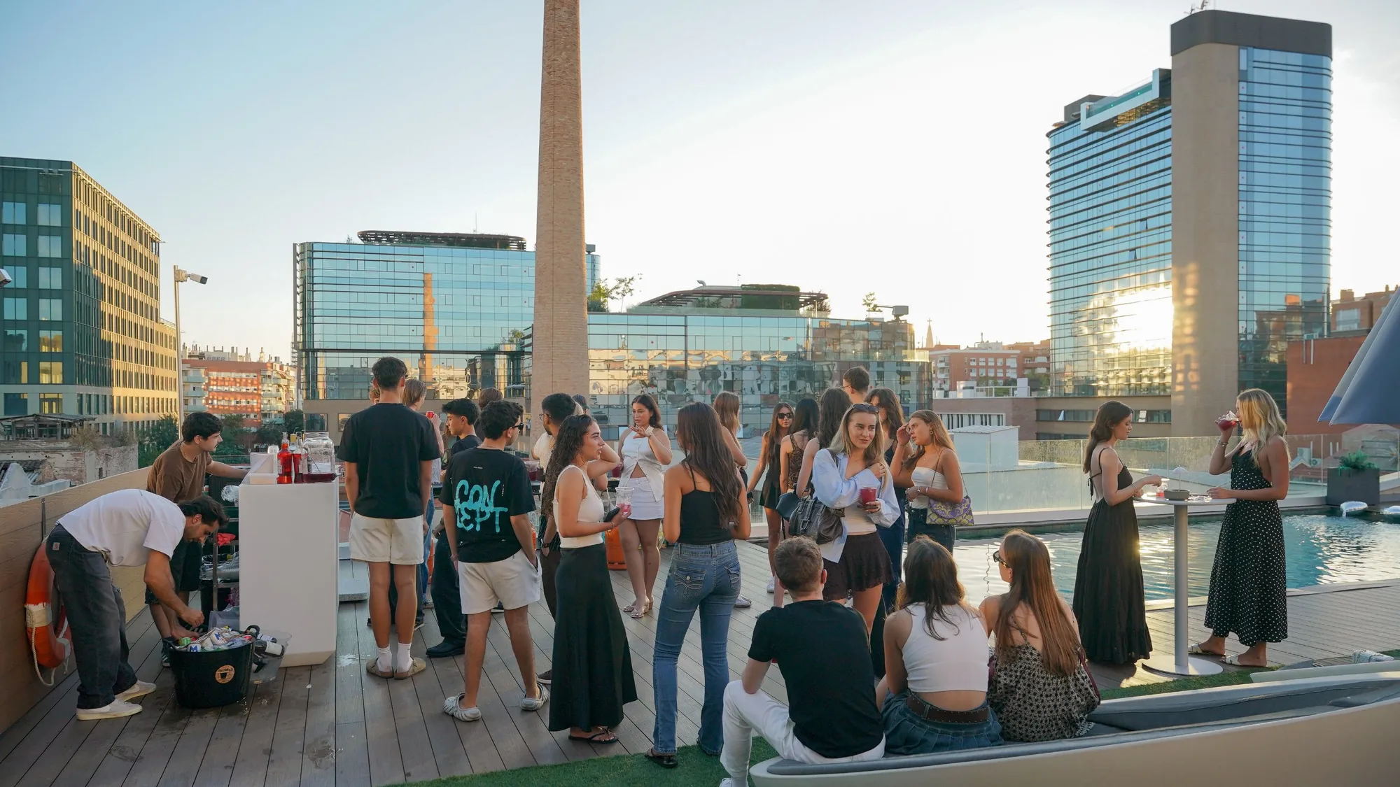 Students at the welcome party on the Blau rooftop at sunset