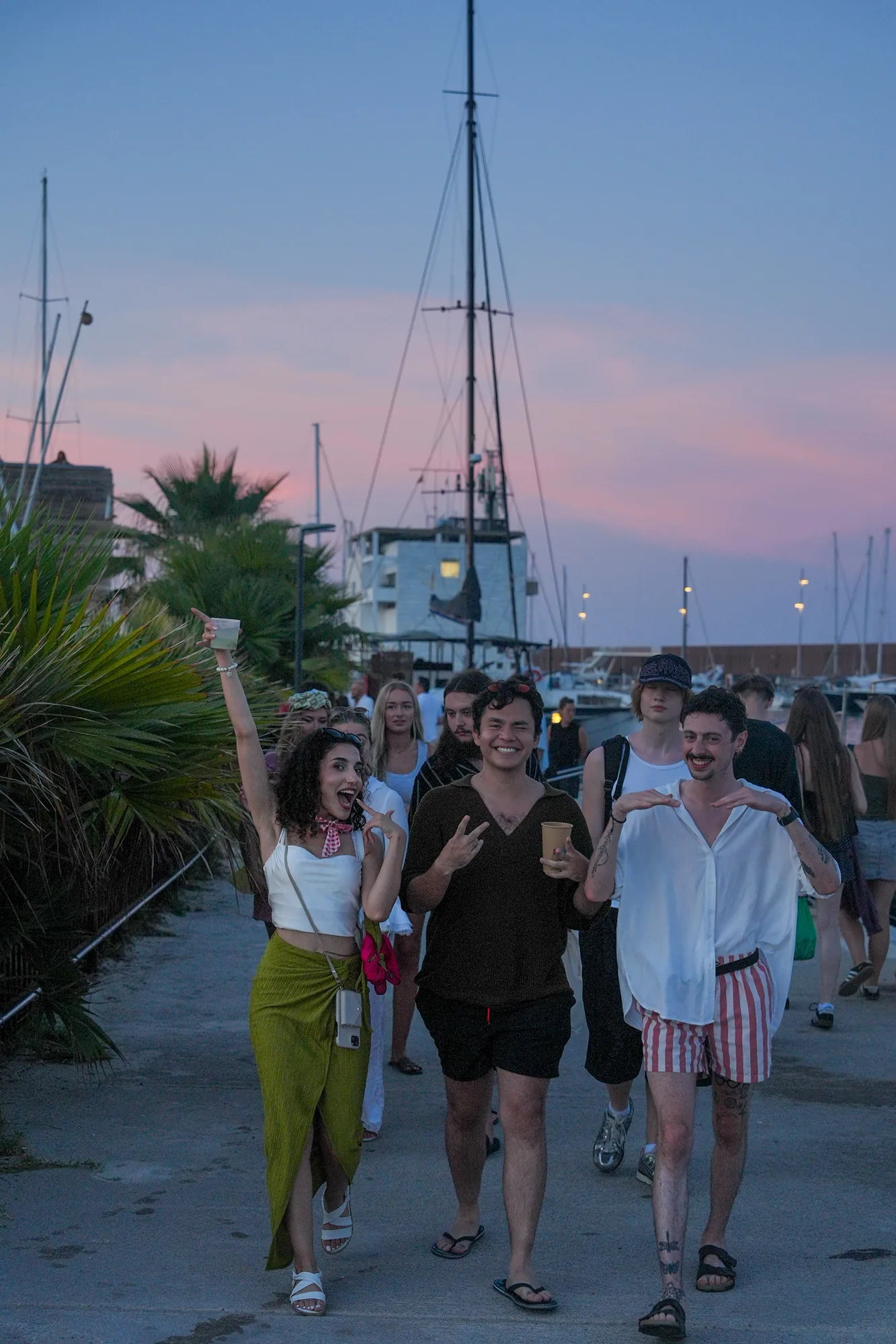 Students on a catamaran at sunset
