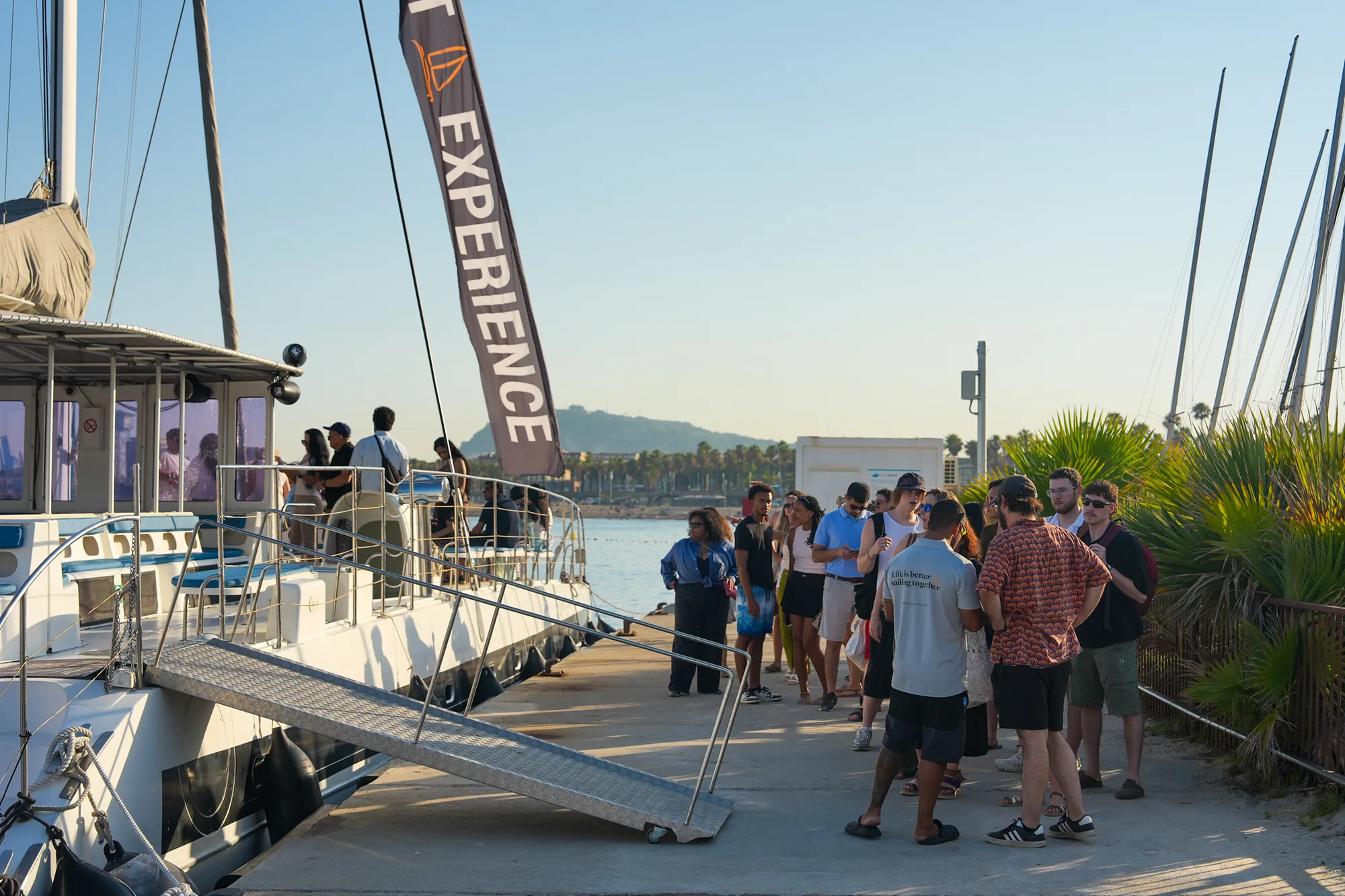 Students boarding a catamaran at Port Olímpic