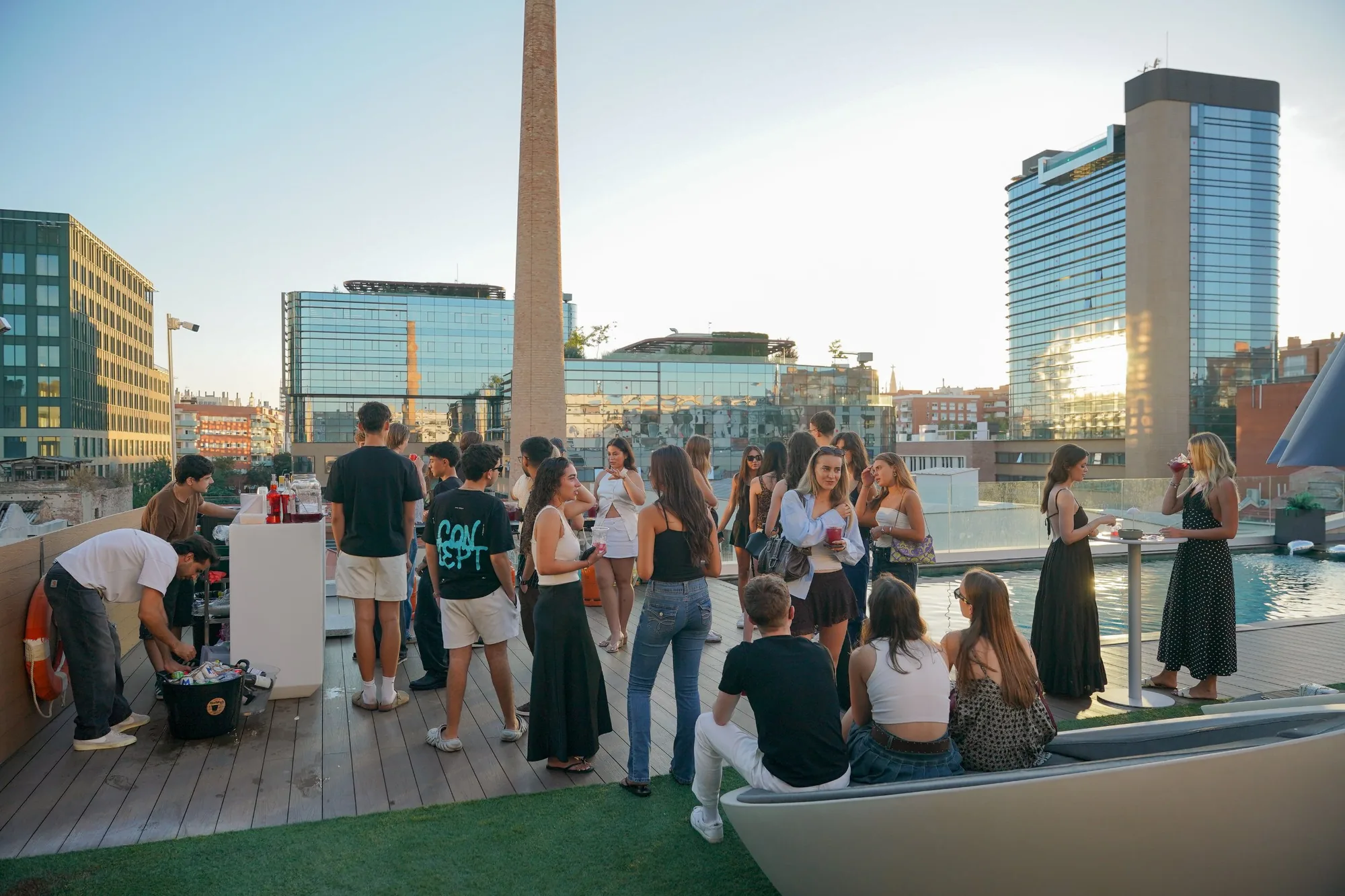 Students at the welcome party on the Blau rooftop at sunset